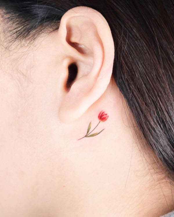 Small flower behind the ear fine line tattoo by @coy.tattoo