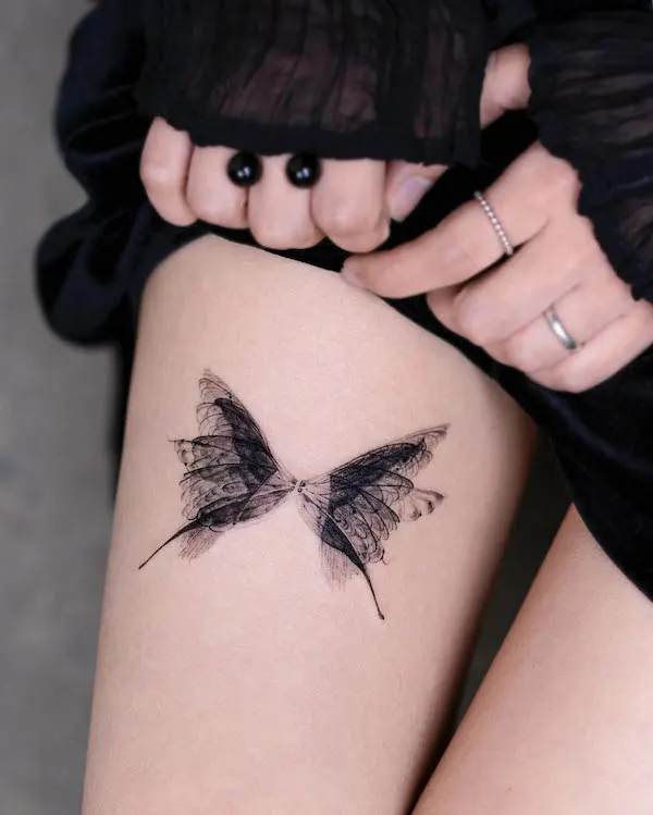 Tatuaje de muslo de mariposa translúcida por @pokhy_tattoo