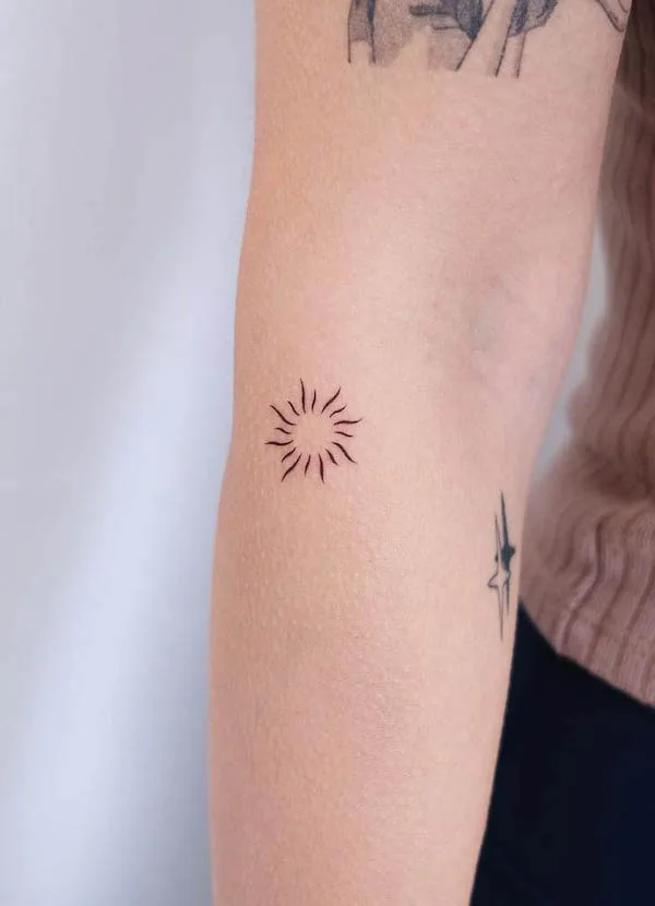 Cute small sun tattoo by @hktattoo_tina